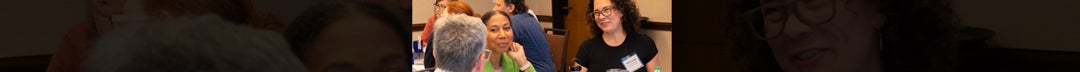 Three individuals sitting at a table, actively discussing and sharing ideas
