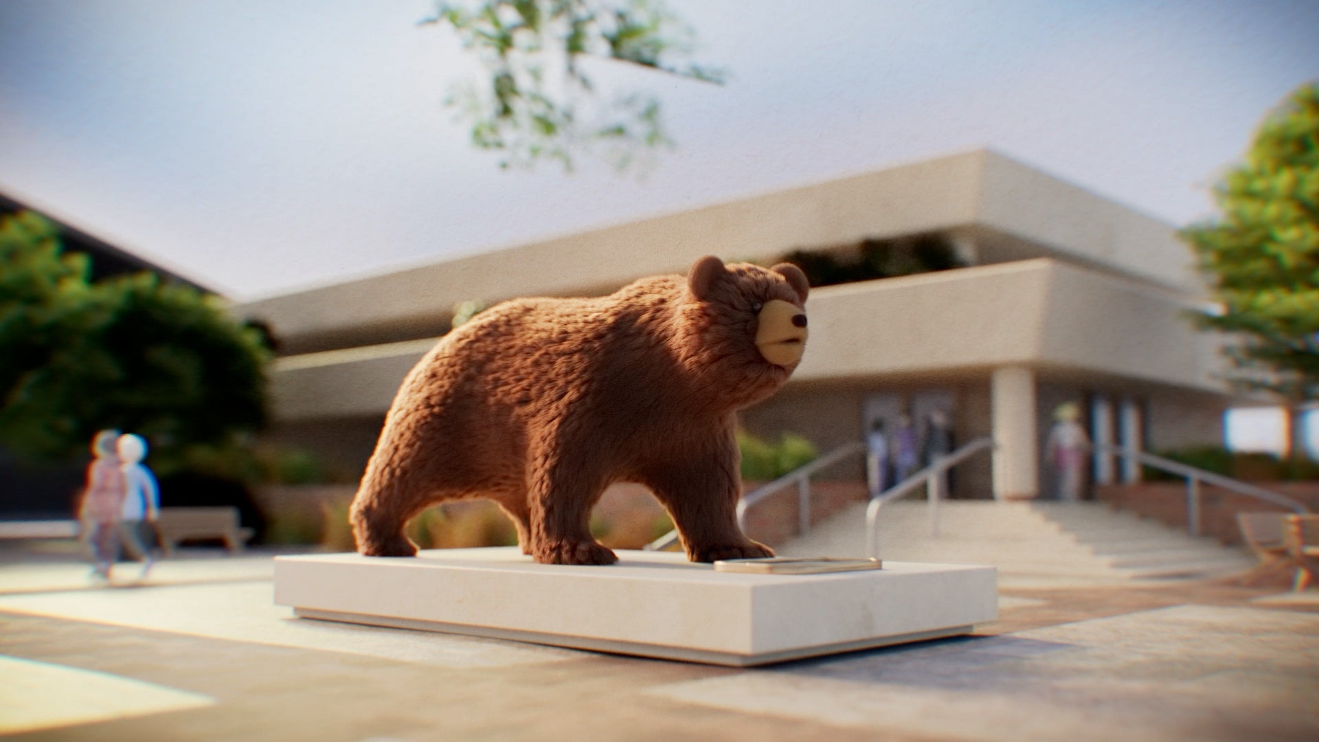 Animated bear statue on a pedestal standing prominently in front of a building